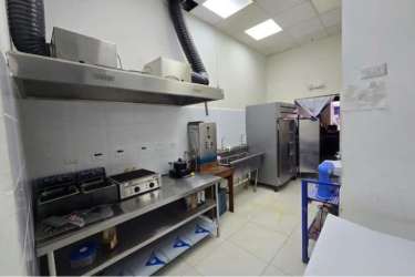Stainless steel commercial kitchen setup with ovens and prep counters inside Westland Mall Panama