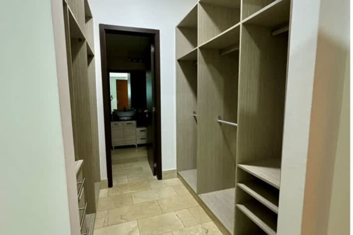 Spacious closet with built-in shelves and storage in luxury Pacific Point apartment Panama City
