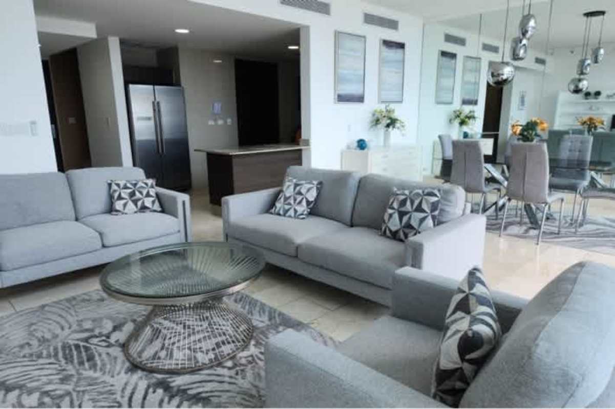 Modern furnished living room with floor-to-ceiling windows at PH Pacific Point Punta Pacífica