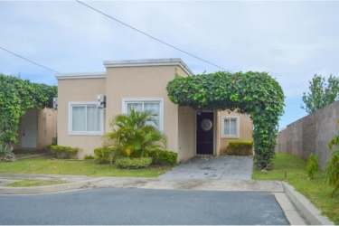 Large outdoor swimming pool with palapa roofs and tropical landscaping in Coronado Residence Panama