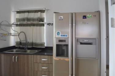 Modern compact kitchen with granite countertops, wood cabinets and stainless appliances Panama