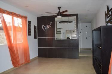 Living space with large windows, tile flooring, and wall decor in Coronado Panama