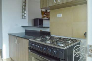 Kitchen setup with granite countertop, gas stove, wood cabinets Coronado Panama