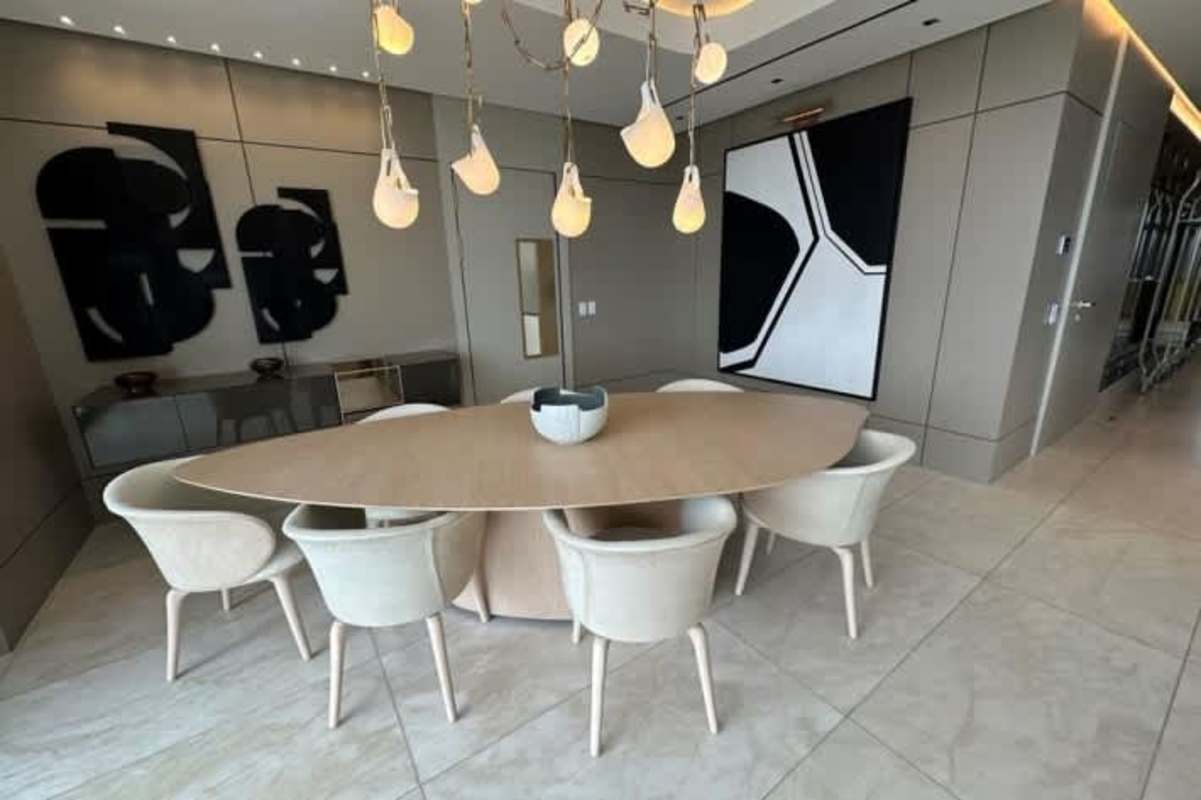 Contemporary dining area with panoramic window views in La Maison by Fendi Casa Santa Maria Panama