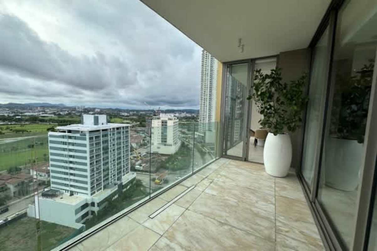 Glass railing balcony overlooking ocean, golf course and city skyline at La Maison by Fendi Casa Panama