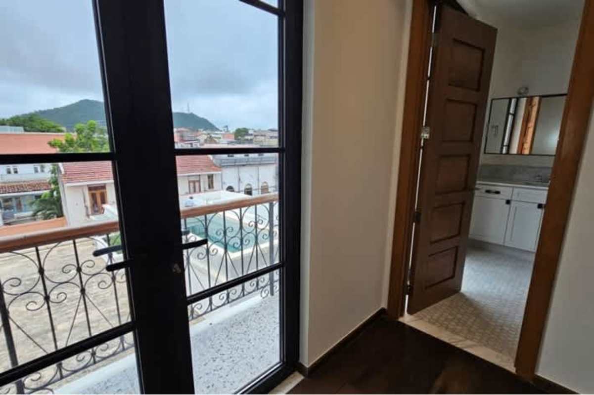 Kitchen with patterned tiles, island and wooden cabinetry at Santa Familia Panama City condo