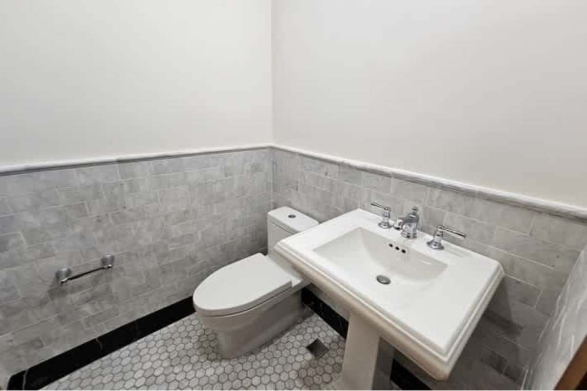 Half bathroom with pedestal sink and tile design at Santa Familia Casco Viejo Panama City