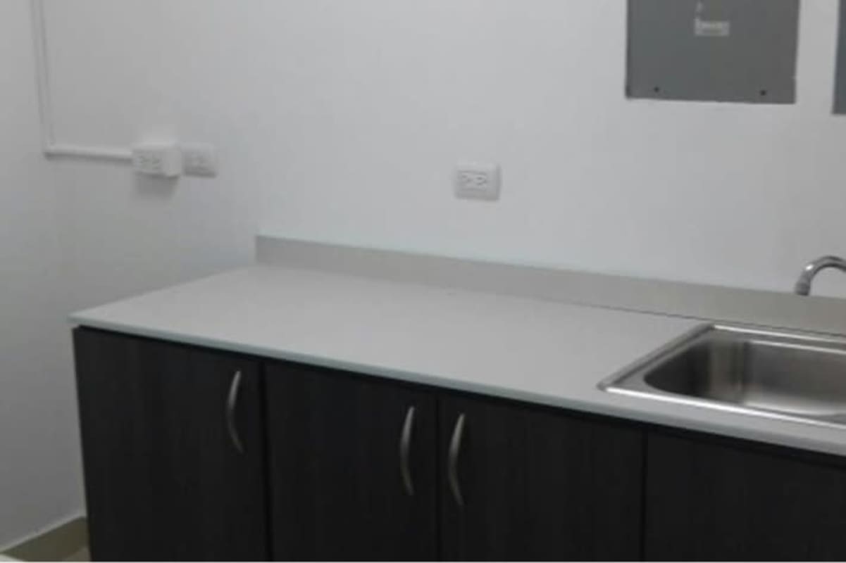 Compact kitchenette with dark cabinets and stainless sink in PH BICSA Financial Center Panama