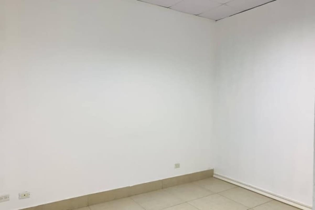 Empty retail unit with white walls tiled floor Terrazas de Albrook Panama for rent