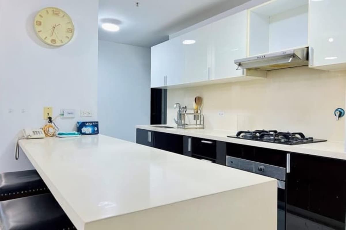 Sleek kitchen with granite counters, stove, built-in oven in rental apartment Villa Lucre Panama