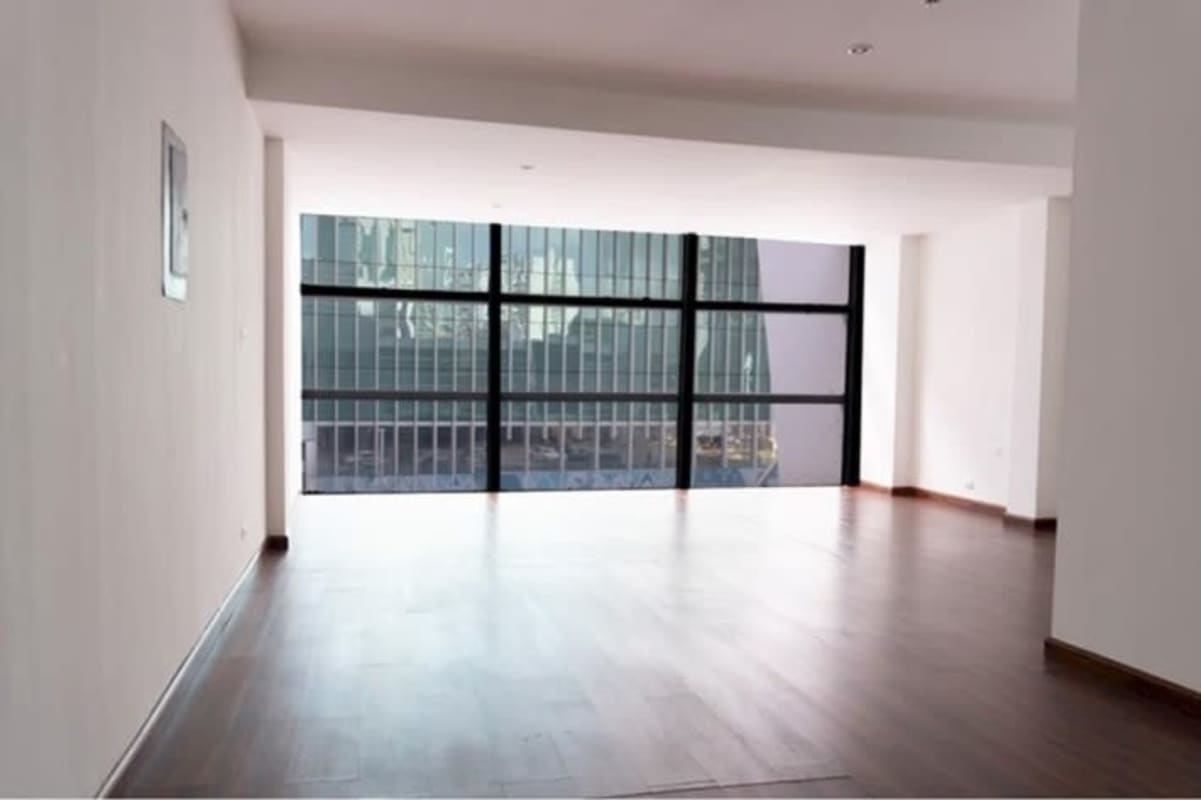 Spacious modern office with hardwood flooring and floor-to-ceiling glass in PH Ocean Business Center
