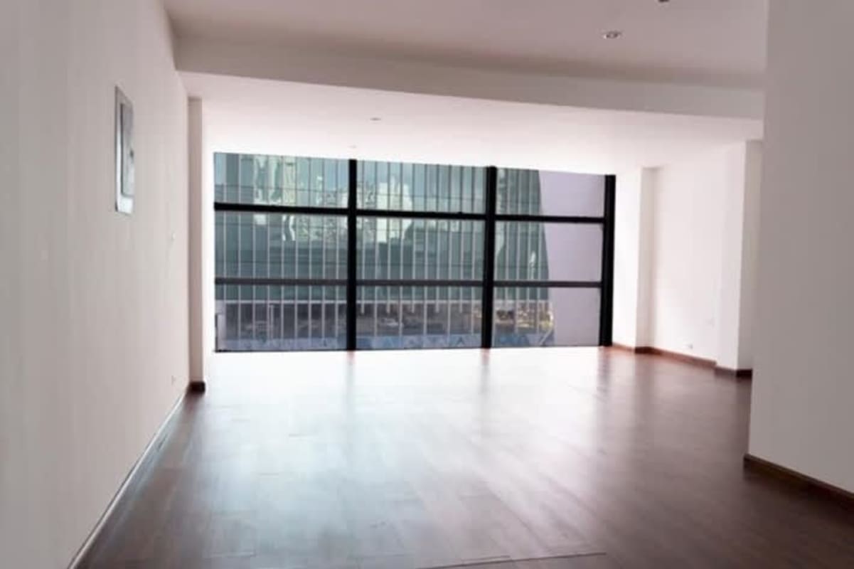 Open office with floor-to-ceiling windows and dark wood floors in Punta Paitilla Panama