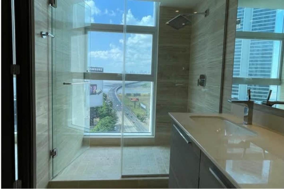 Modern bathroom with marble countertops and glass shower at PH Mahogany Panama