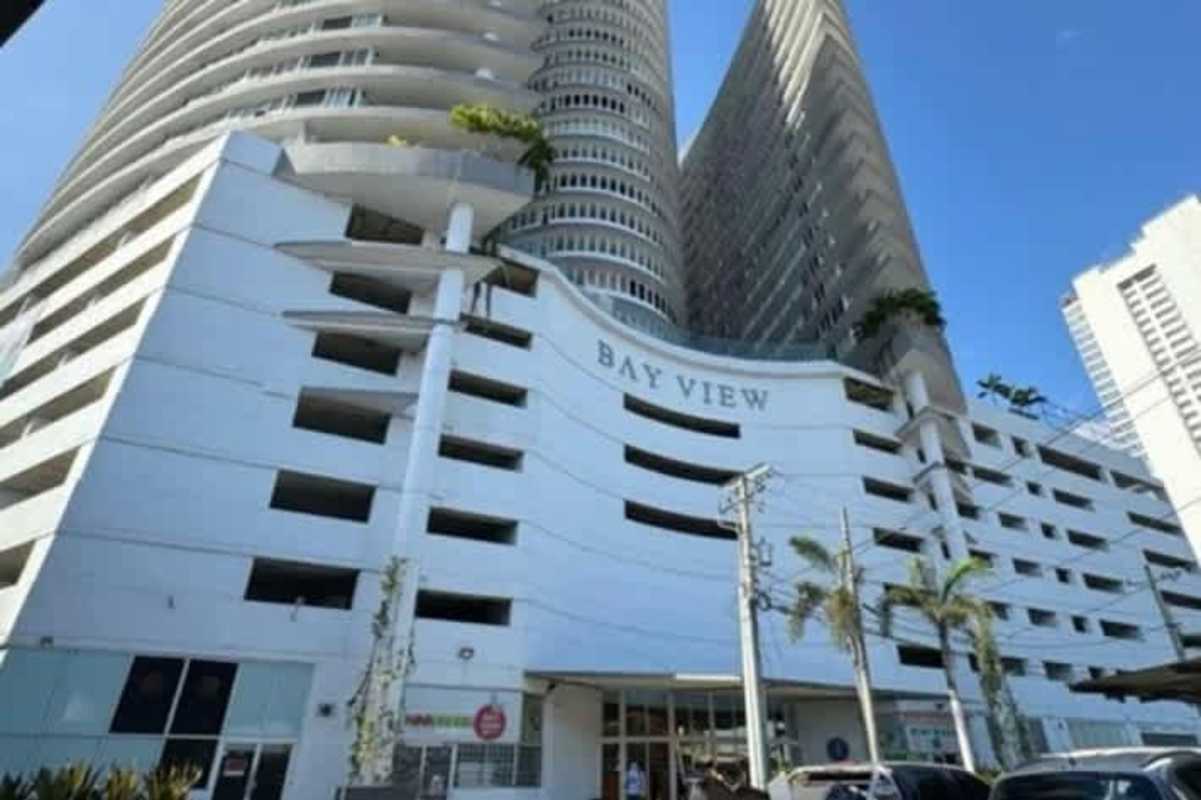 Living dining room with large windows, ocean views, balcony access in PH Bay View Avenida Balboa Panama