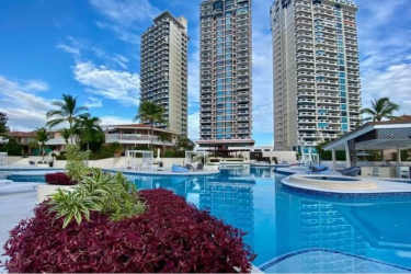 Modern dining area with kitchen view in beachfront condo at PH Coronado Country Club Panama