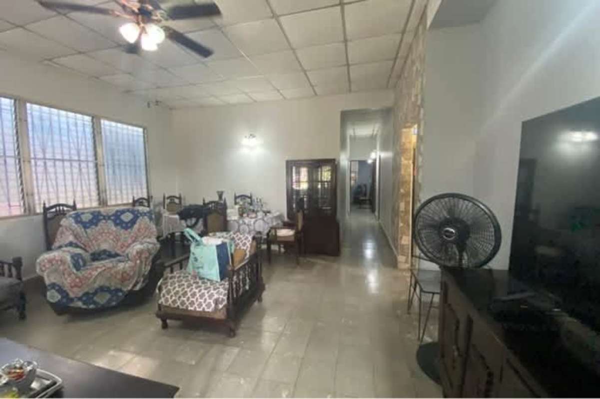 Vintage kitchen with gas stove, turquoise cabinets, barred windows in Rio Abajo Panama house