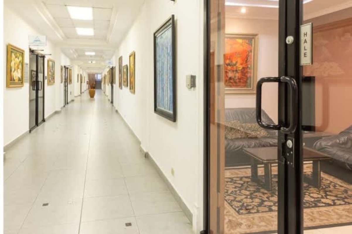 Modern hallway with sofas, coffee table and glass doors in a commercial building Panama City