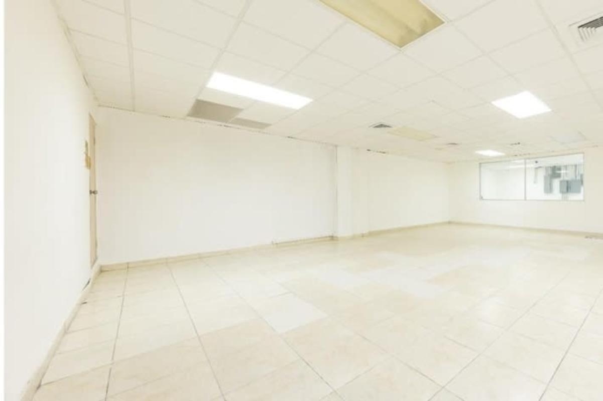 Empty bright commercial office space with tiled floor drop ceiling large windows in PH Vista Hermosa Panama