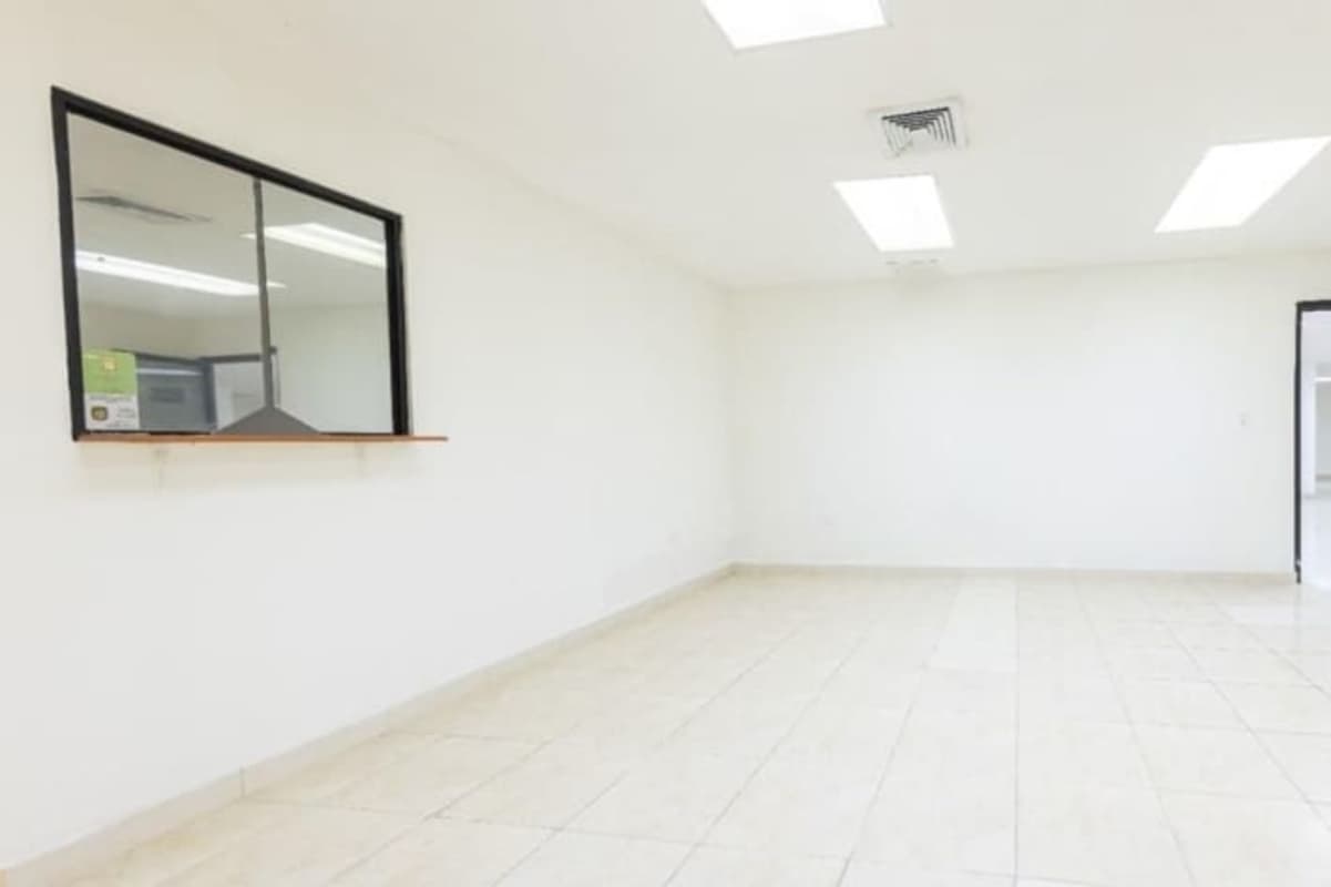 Empty reception office area with window opening tiled floors white walls Torre Empresarial Vista Hermosa Panama
