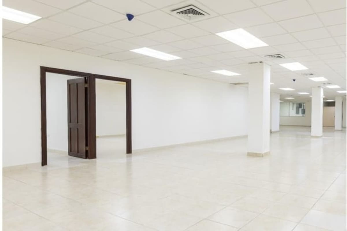 Open commercial space with tiled floor drop ceiling support beams Vista Hermosa Panama