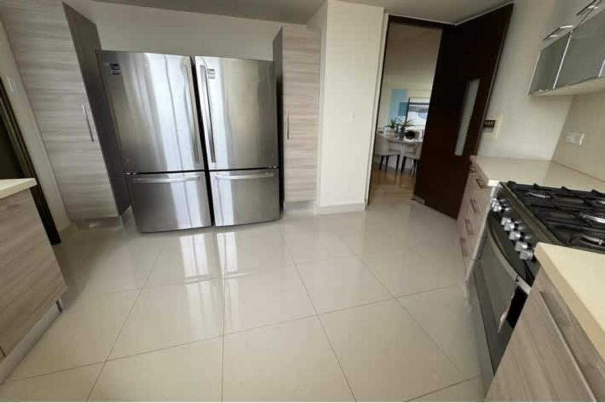 Modern bedroom with floor to ceiling windows, blue feature wall, panoramic ocean view PH Mirador Costa del Este Panama