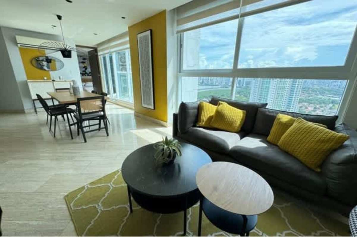 Dining room with large windows and city skyline views in upscale PH Costa del Este rental