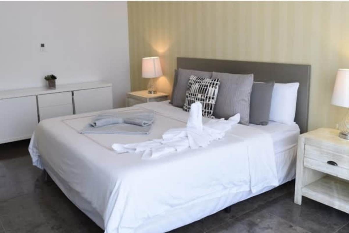 Luxury bedroom king bed accent wall towel decor Yoo Panama Panama City