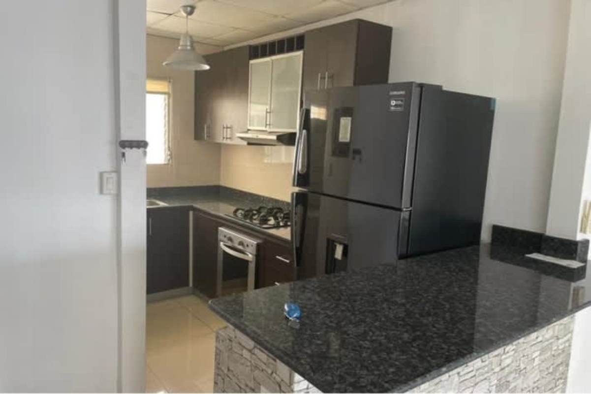 Modern kitchen with granite counters, dark wood cabinets in condado country club condo Panama