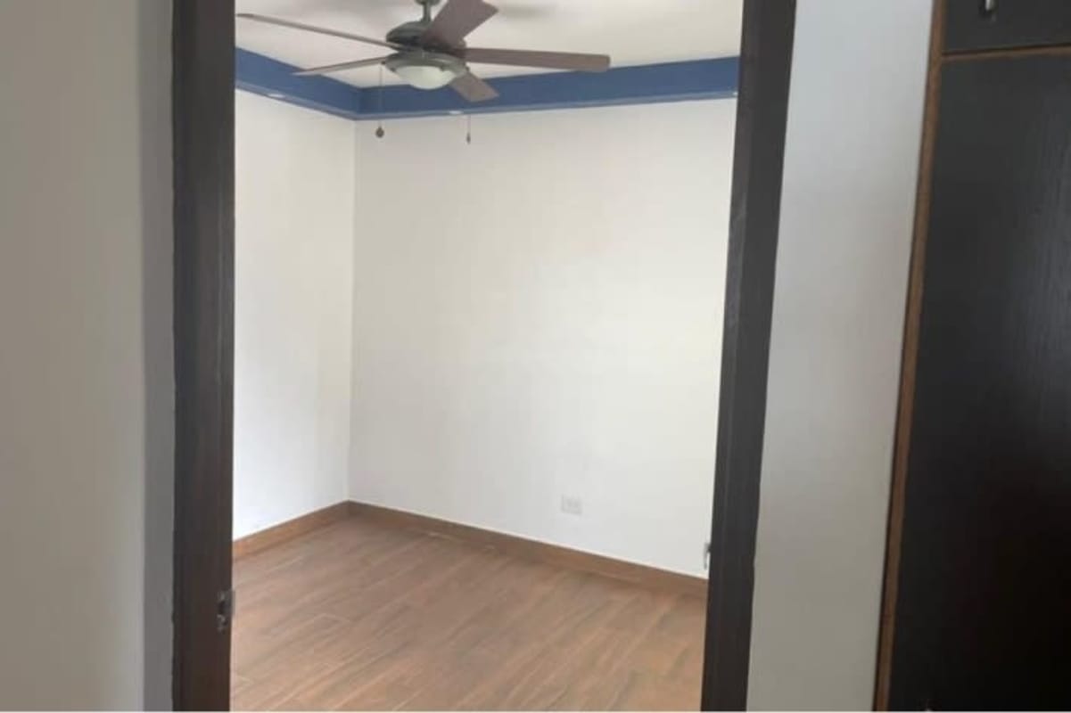 Bedroom with laminate wood flooring and closet Condado Country Club Panama