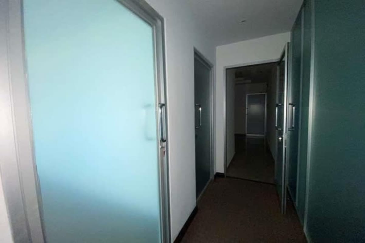 Hallway with frosted glass doors in commercial tower Credicorp Bank Obarrio Panama
