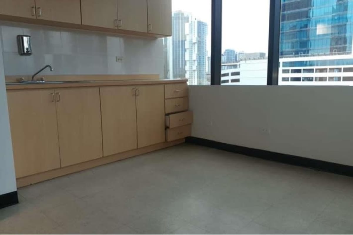 Small kitchenette area with cabinets sink and large windows in PH Plaza Credicorp Bank Panama