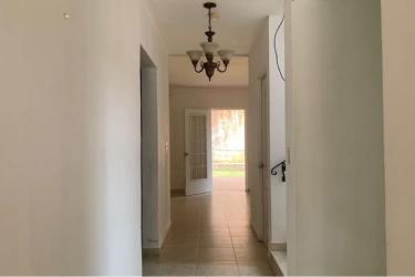Minimalist empty room with large window, tiled floors in Altos de María Leticia La Chorrera