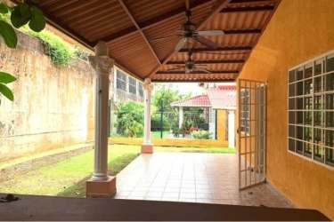 Mediterranean tiled patio area with columns, ceiling fans, garden view in Altos de María Leticia Panama
