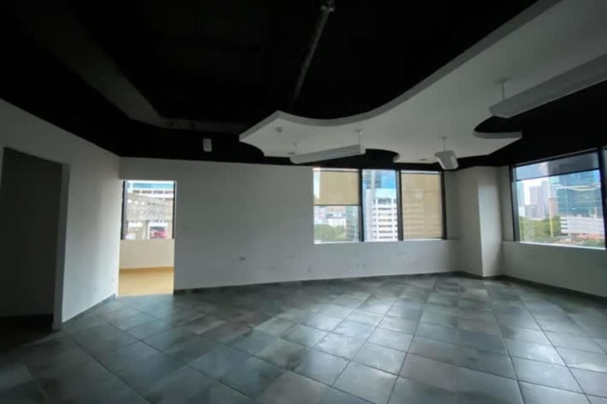 Modern minimal office with large windows tile flooring black exposed ceiling Plaza Credicorp Bank Panama