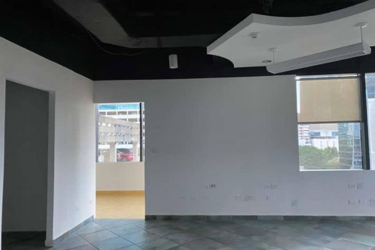 Modern clean office interiors with drop ceilings glass partitions tile floors Plaza Credicorp Bank Panama City
