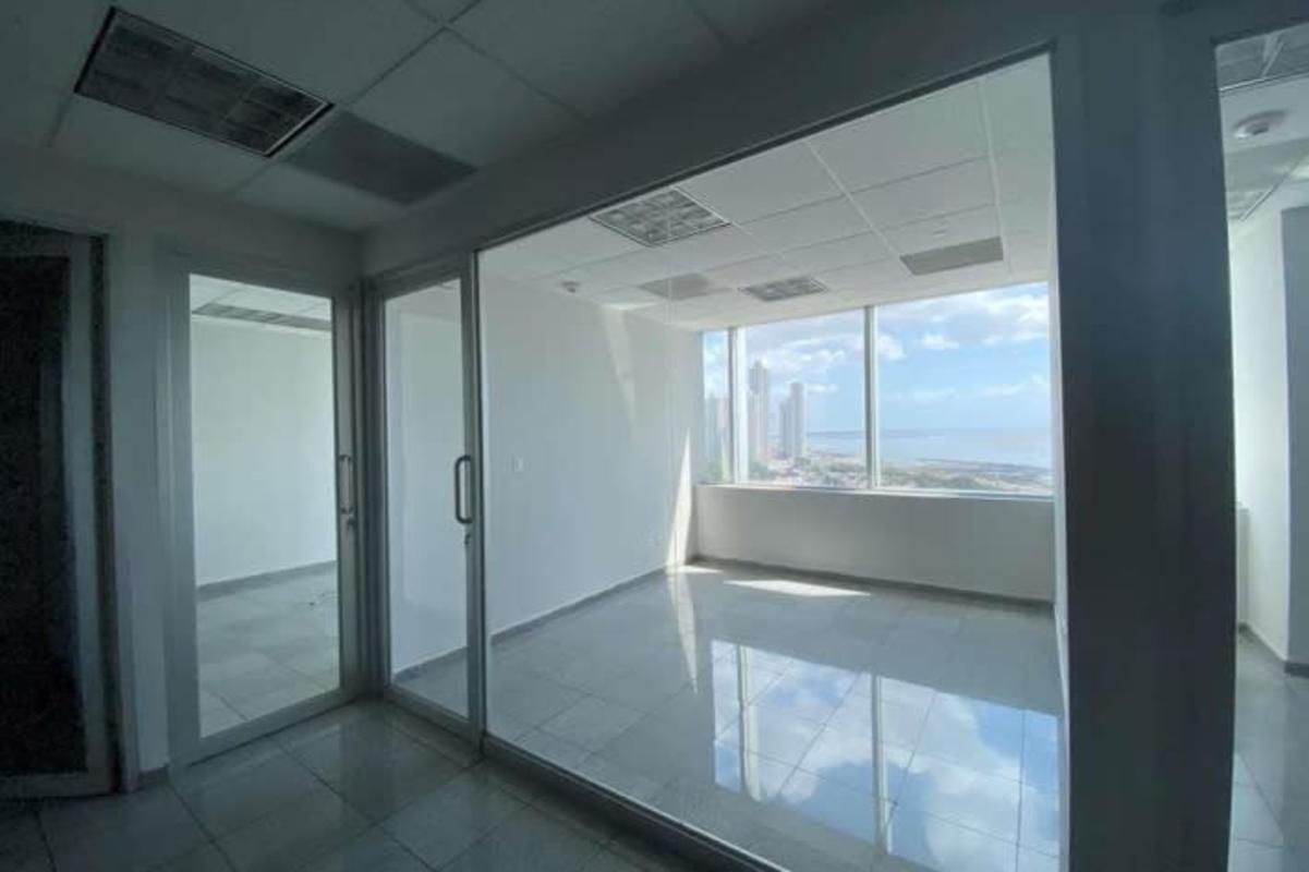 Modern executive office space with floor-to-ceiling window overlooking ocean in Torre de Las Américas Panama