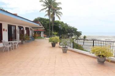 Large tiled terrace with wrought iron railings and coastal views at luxury beachfront estate Guanico Antón Panama