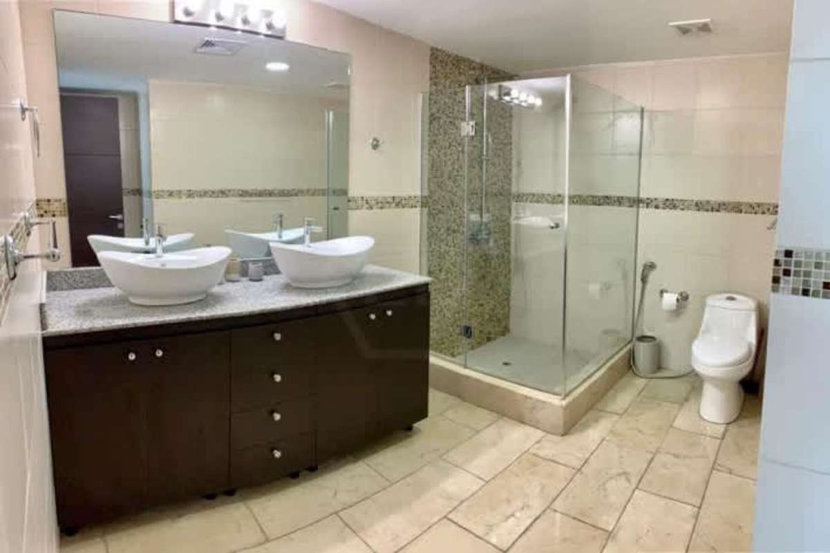 Contemporary bathroom double sinks and glass enclosure in Punta Pacifica Grand Tower Panama