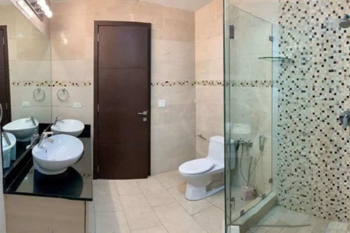 Modern bathroom with mosaic accent wall and glass shower at Grand Tower Panama