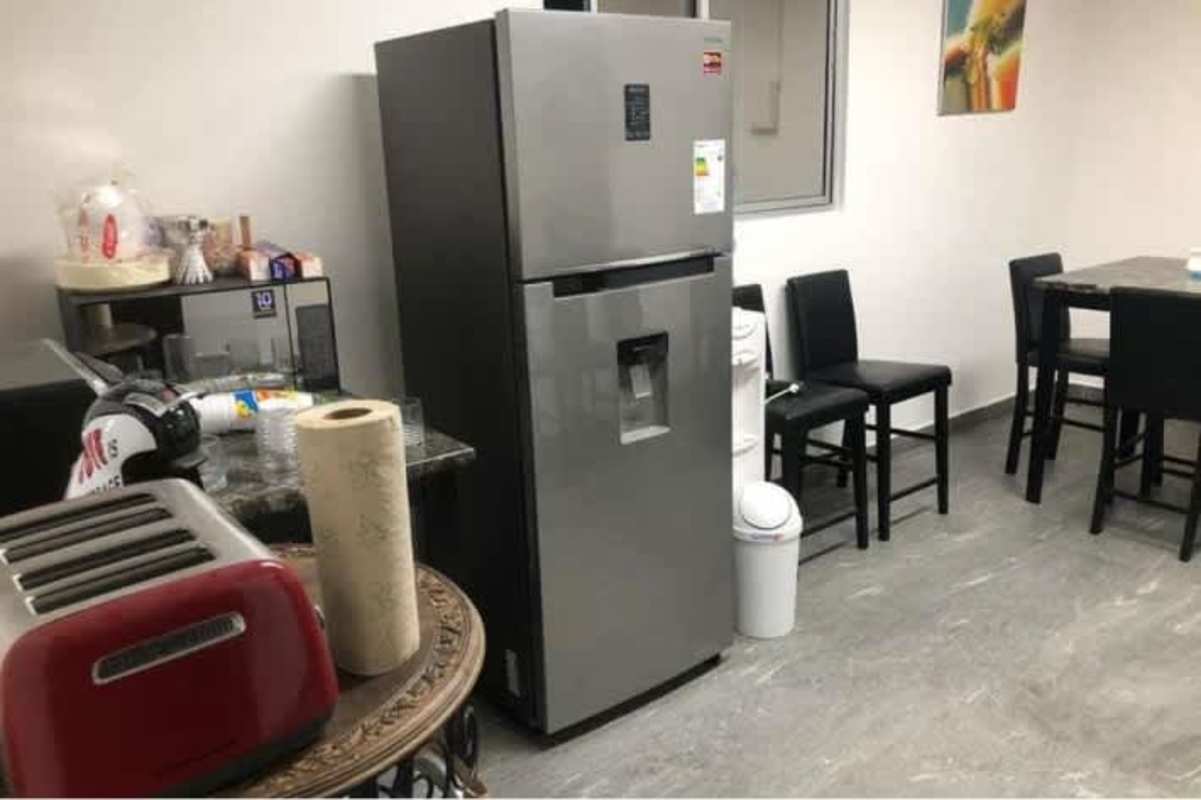 Office kitchen featuring stainless refrigerator, marble counter, appliances Parque Industrial Costa del Este