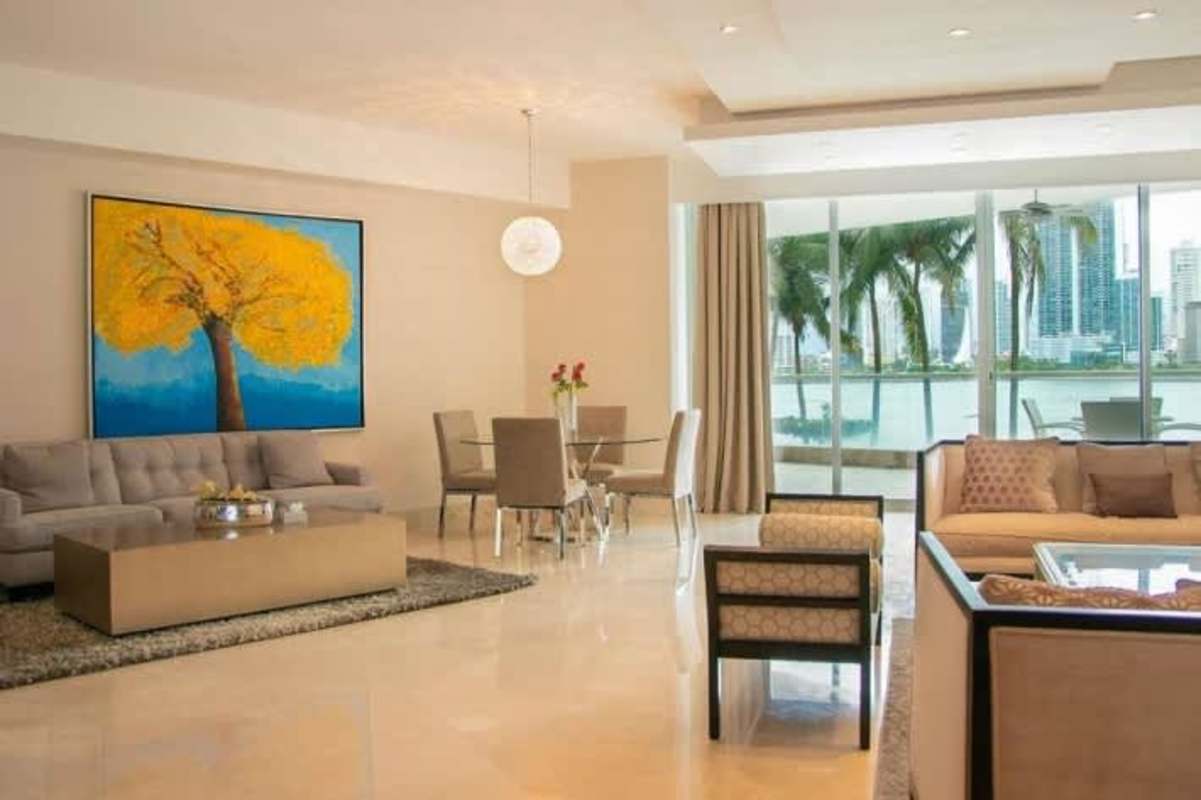 Dining and living room with skyline views, bright artwork, neutral furnishings in PH Miradores Punta Paitilla
