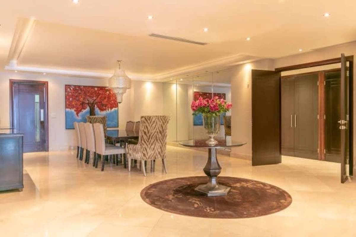 Modern master bedroom with large windows, neutral decor and city views at PH Miradores