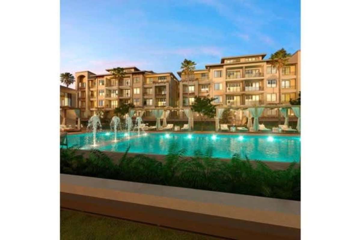 Exterior night view of Casa Bianca apartment buildings with street lighting and palm trees Costa del Este Panama