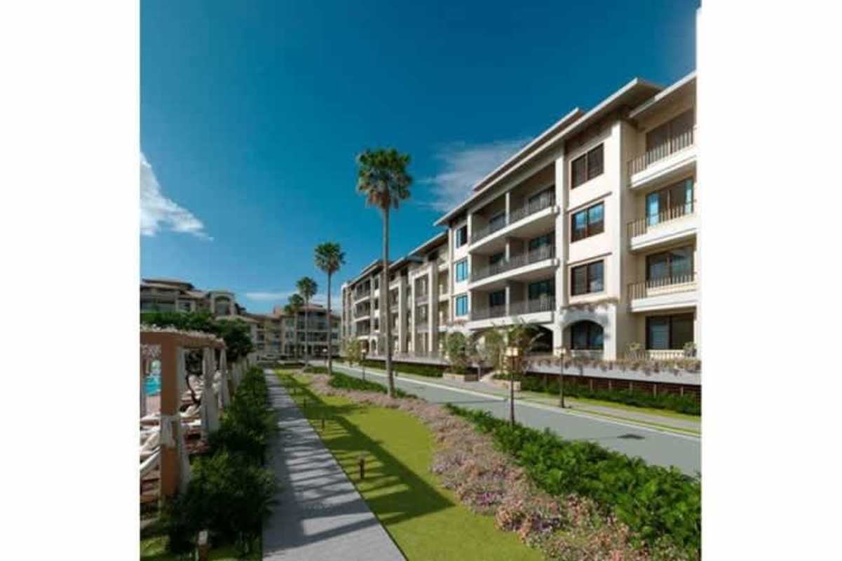 Multi-story Mediterranean style buildings with balconies, gardens, and palm trees at Casa Bianca Costa del Este Panama