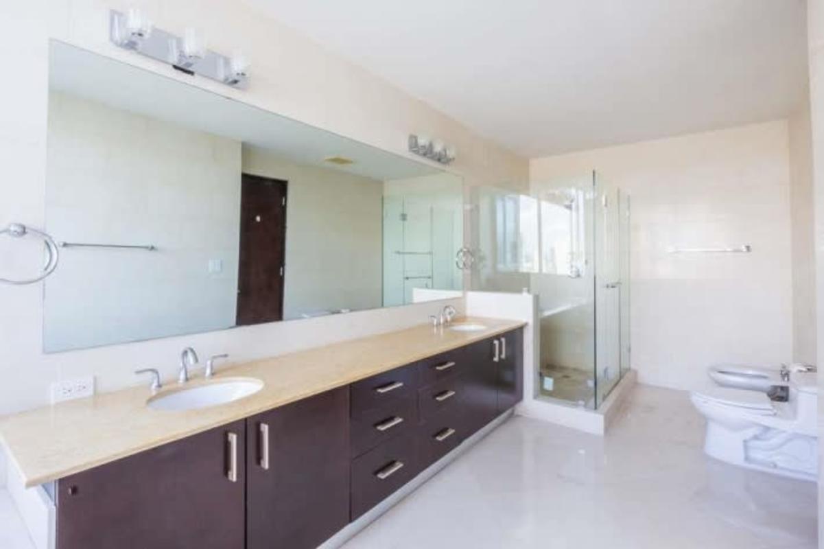 Luxury bathroom with double sink vanity, marble, glass enclosed shower at The Point