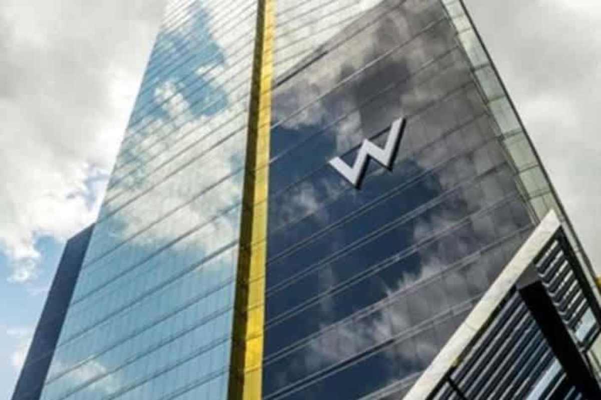 Tall skyscraper Evolution Tower with W hotel sign Panama City skyline