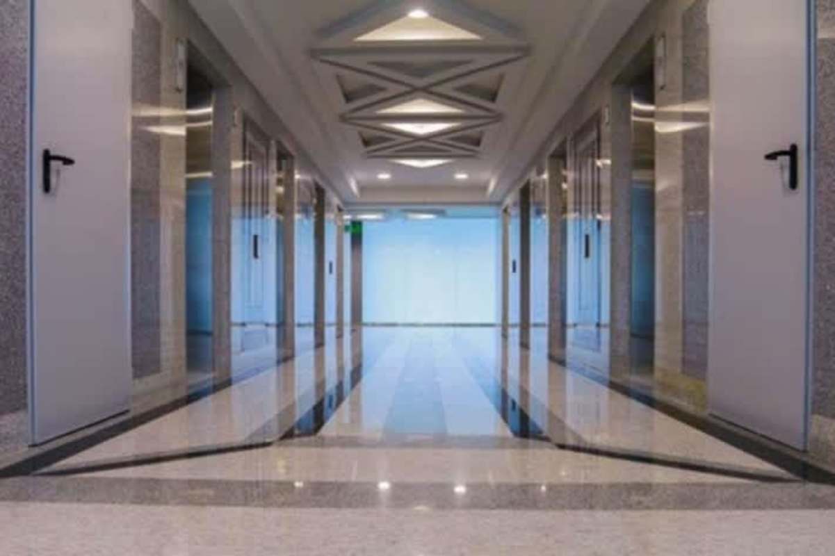Elevator lobby with marble flooring and geometric ceilings at Evolution Tower Panama