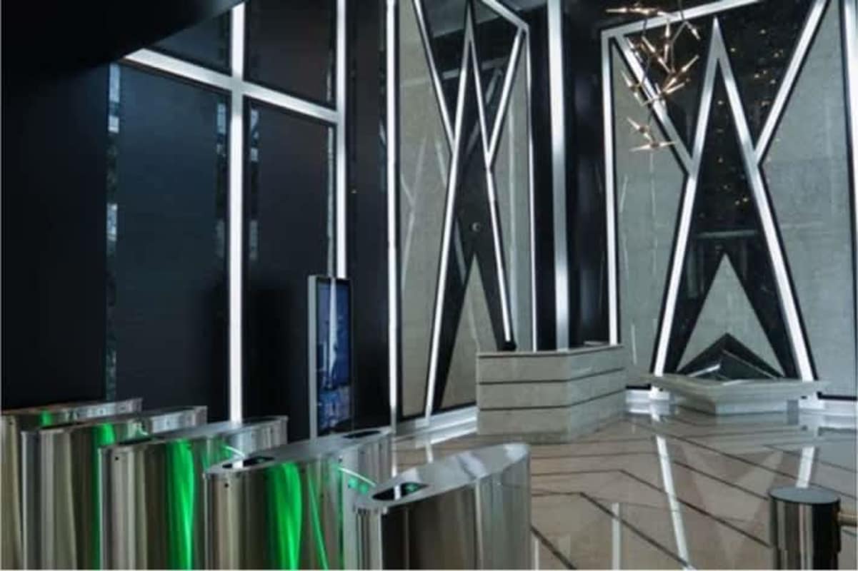 Illuminated geometric wall designs and stainless entry turnstiles at Evolution Tower