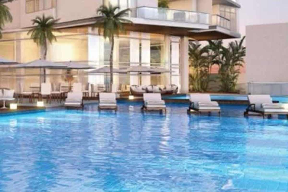 Modern glass twin towers of PH Costanera with palm trees on Avenida Balboa Panama