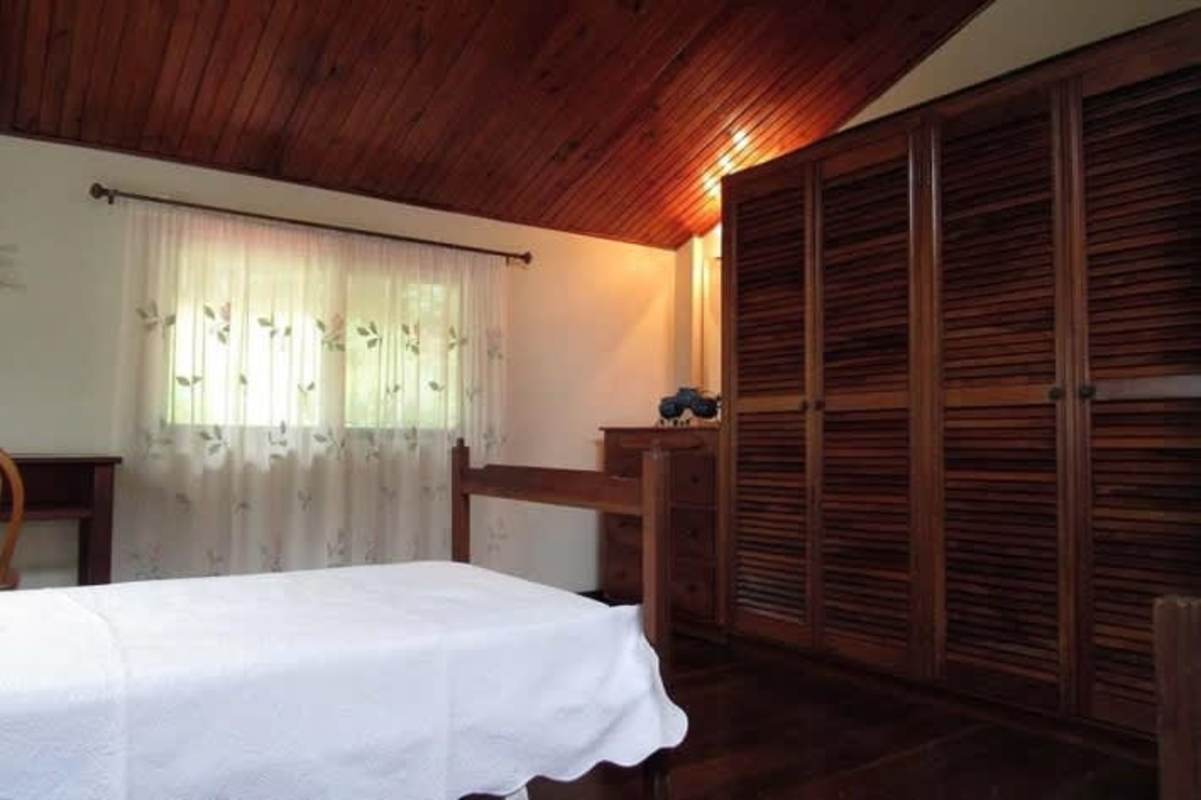 Traditional dining area with wood table and chairs in mountain home Cerro Azul
